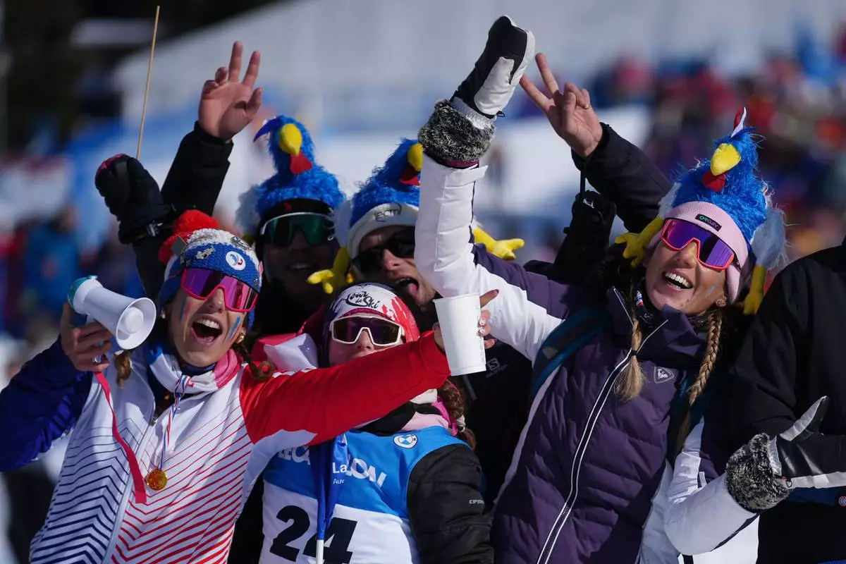 Fans of France wait for the start of the men's 15-kilometer mass start biathlon race at the 2026 Winter Olympics in Anterselva, Italy, Friday, Feb. 20, 2026. (AP Photo/Andrew Medichini)