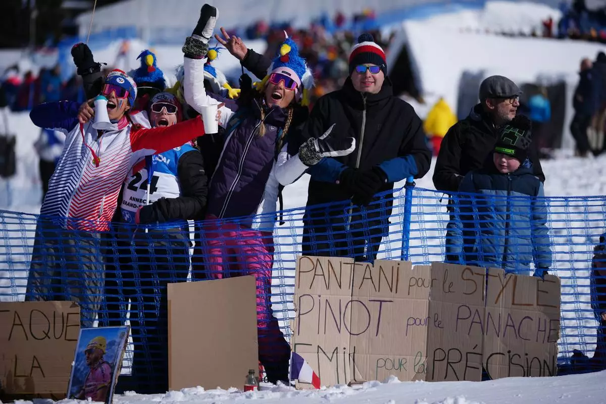 Fans of France wait for the start of the men's 15-kilometer mass start biathlon race at the 2026 Winter Olympics in Anterselva, Italy, Friday, Feb. 20, 2026. (AP Photo/Andrew Medichini)