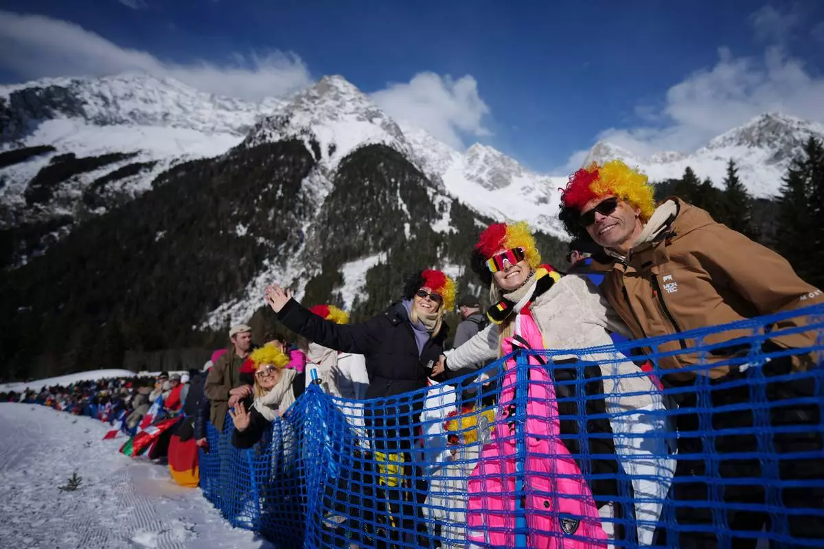 Fans of Germany wait for the start of the men's 15-kilometer mass start biathlon race at the 2026 Winter Olympics in Anterselva, Italy, Friday, Feb. 20, 2026. (AP Photo/Andrew Medichini)