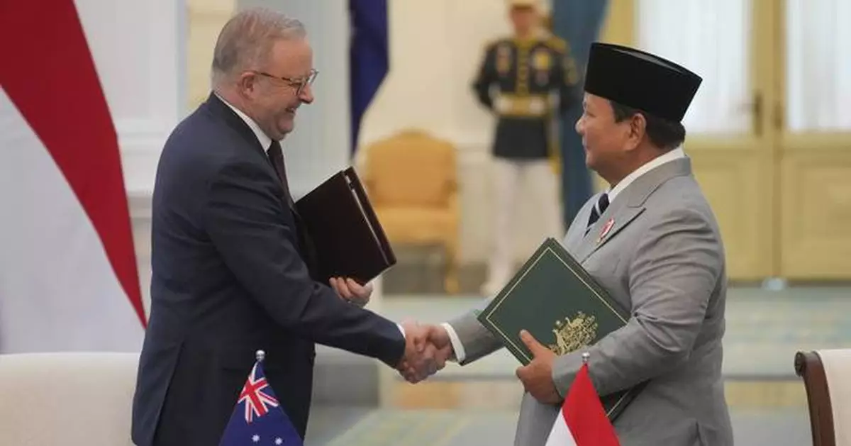 Leaders of Indonesia and Australia sign a new security treaty to affirm deeper ties