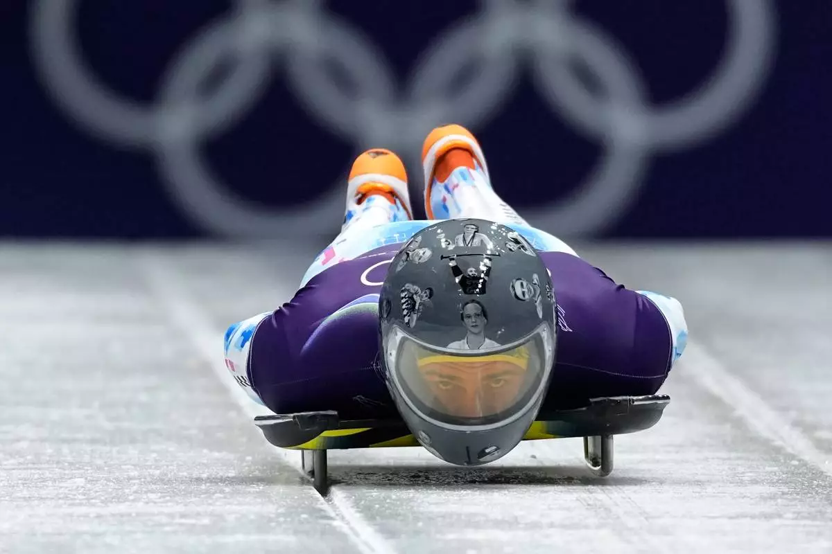 Ukraine's Vladyslav Heraskevych starts for a men's skeleton training session at the 2026 Winter Olympics, in Cortina d'Ampezzo, Italy, Wednesday, Feb. 11, 2026. (AP Photo/Aijaz Rahi)
