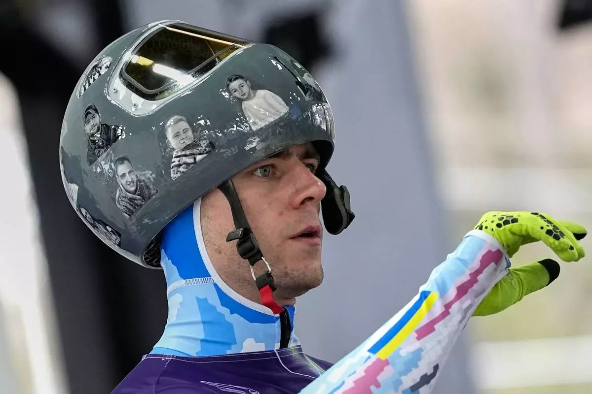 Ukraine's Vladyslav Heraskevych arrives at the finish during a men's skeleton training session at the 2026 Winter Olympics, in Cortina d'Ampezzo, Italy, Tuesday, Feb. 10, 2026. (AP Photo/Alessandra Tarantino)