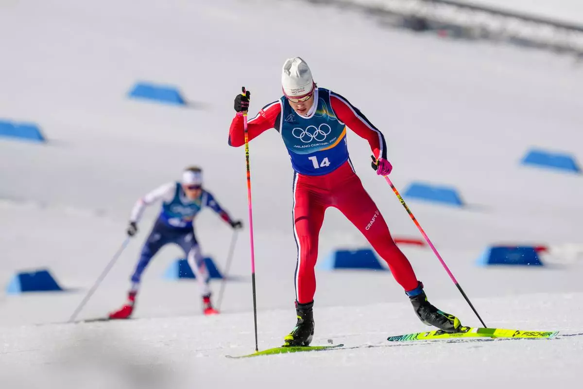 Johannes Hoesflot Klaebo, of Norway, leads Victor Lovera, of France, left, during the cross country skiing men's 4 x 7.5km relay at the 2026 Winter Olympics, in Tesero, Italy, Sunday, Feb. 15, 2026. (AP Photo/Evgeniy Maloletka)