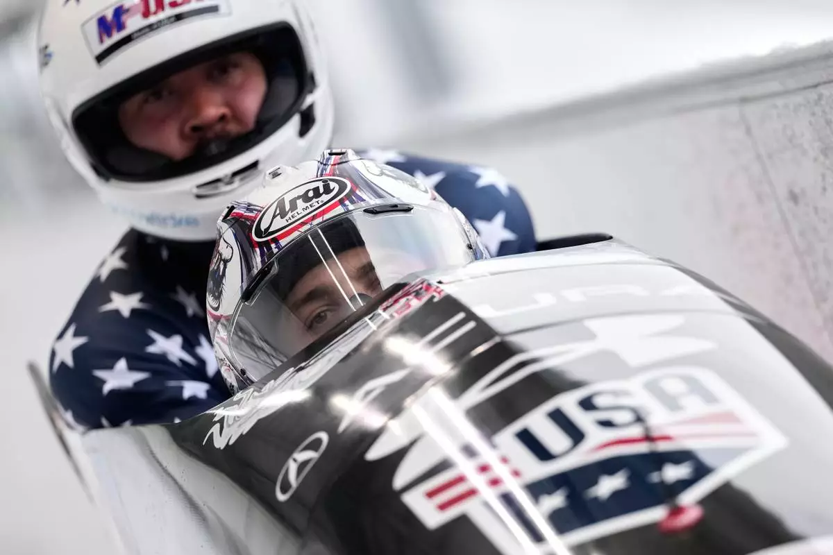 FILE - Kristopher Horn and Carsten Vissering of the United States arrive at the finish during the 2-man bobsled, at the Bobsled World Cup in Innsbruck, Austria, Nov. 29, 2025. (AP Photo/Matthias Schrader, File)