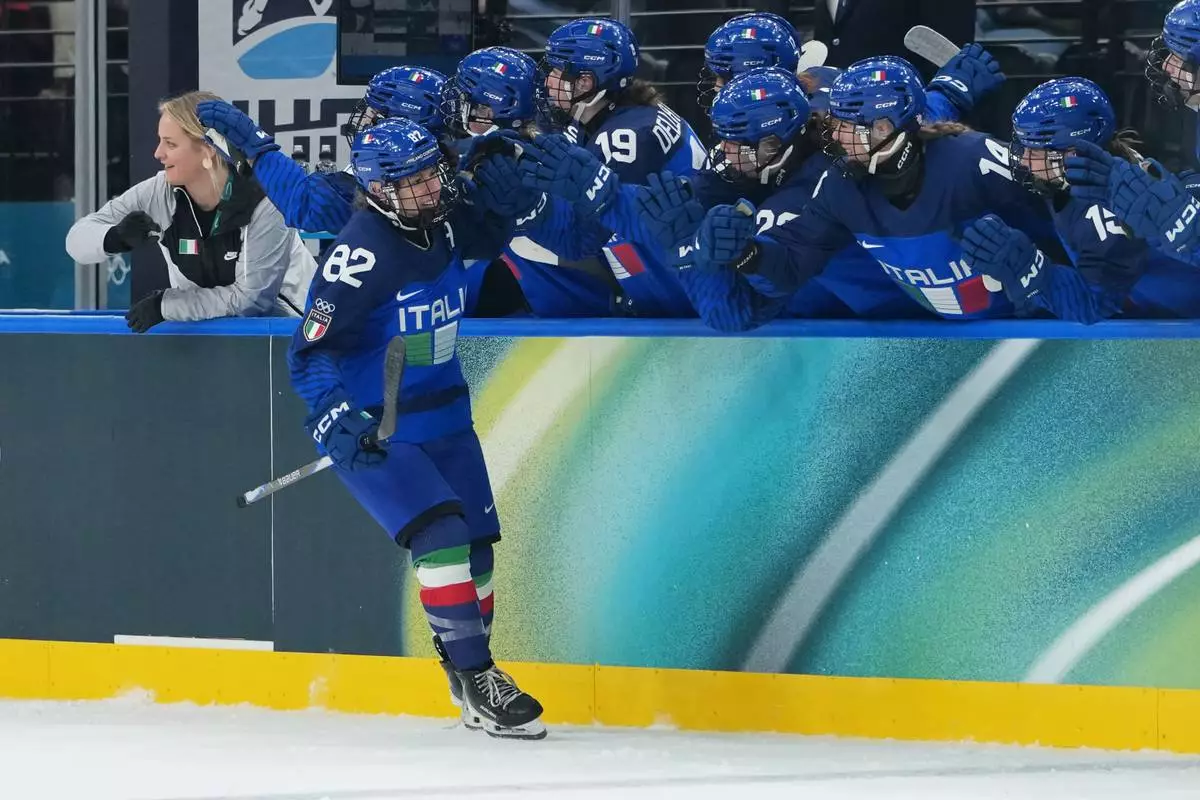 Italy's Kayla Tutino (82) celebrates after scoring a goal in the first period during a preliminary round match of women's ice hockey against France at the 2026 Winter Olympics, in Milan, Italy, Thursday, Feb. 5, 2026. (AP Photo/Carolyn Kaster)