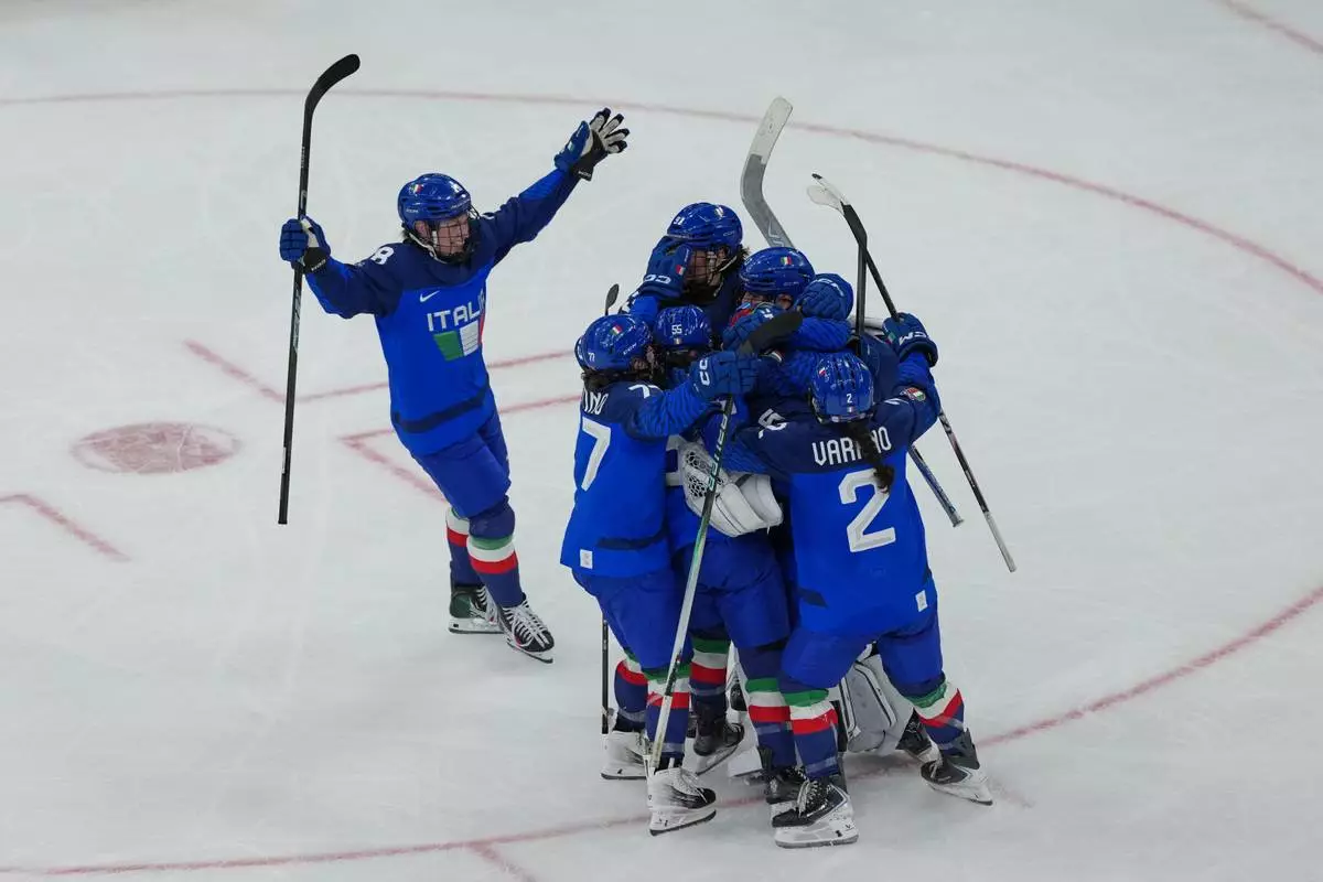 Italy's Franziska Stocker (18) skates to celebrate with teammates after winning a preliminary round match of women's ice hockey against France at the 2026 Winter Olympics, in Milan, Italy, Thursday, Feb. 5, 2026. (AP Photo/Carolyn Kaster)