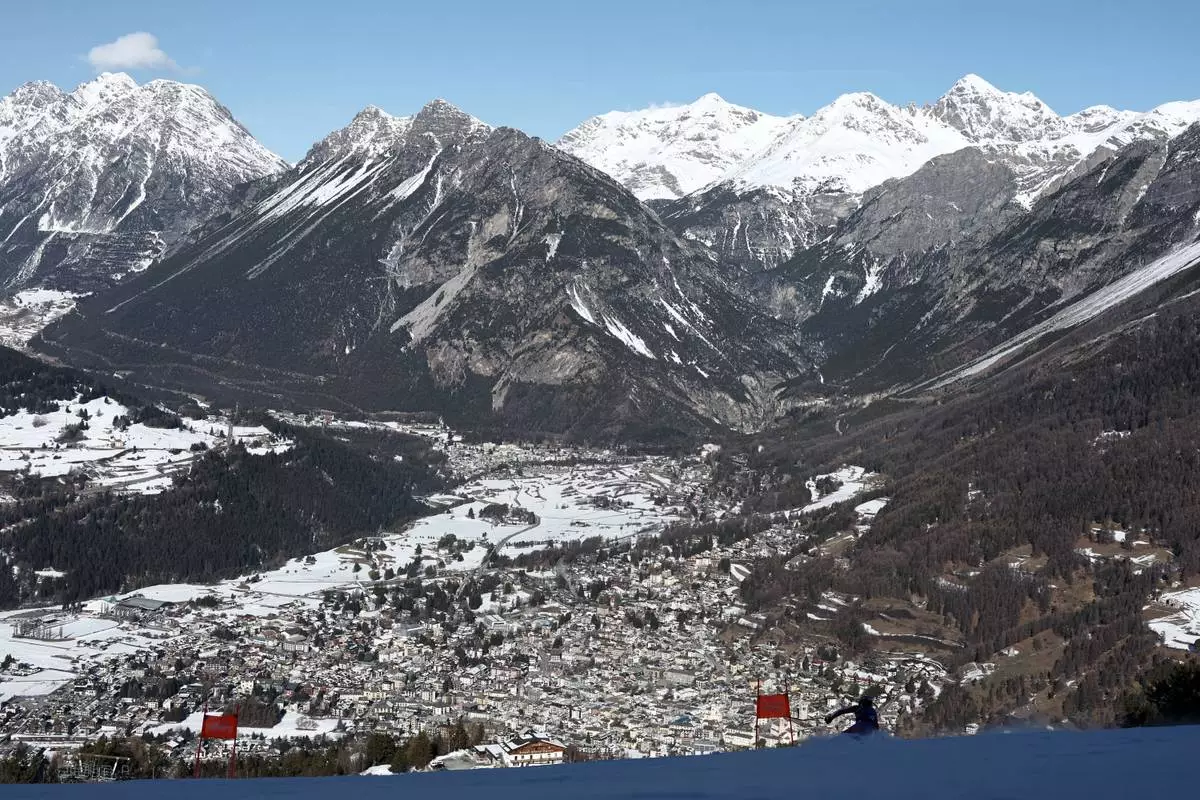 France's Maxence Muzaton speeds down the course of an alpine ski men's downhill portion of a team combined race, at the 2026 Winter Olympics, in Bormio, Italy, Monday, Feb. 9, 2026. (AP Photo/Gabriele Facciotti)