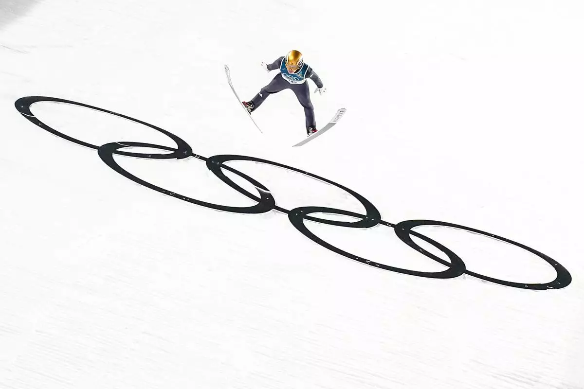 Philipp Raimund, of Germany, soars through the air during his final round jump in the ski jumping men's normal hill individual at the 2026 Winter Olympics, in Predazzo, Italy, Monday, Feb. 9, 2026. (AP Photo/Matthias Schrader)