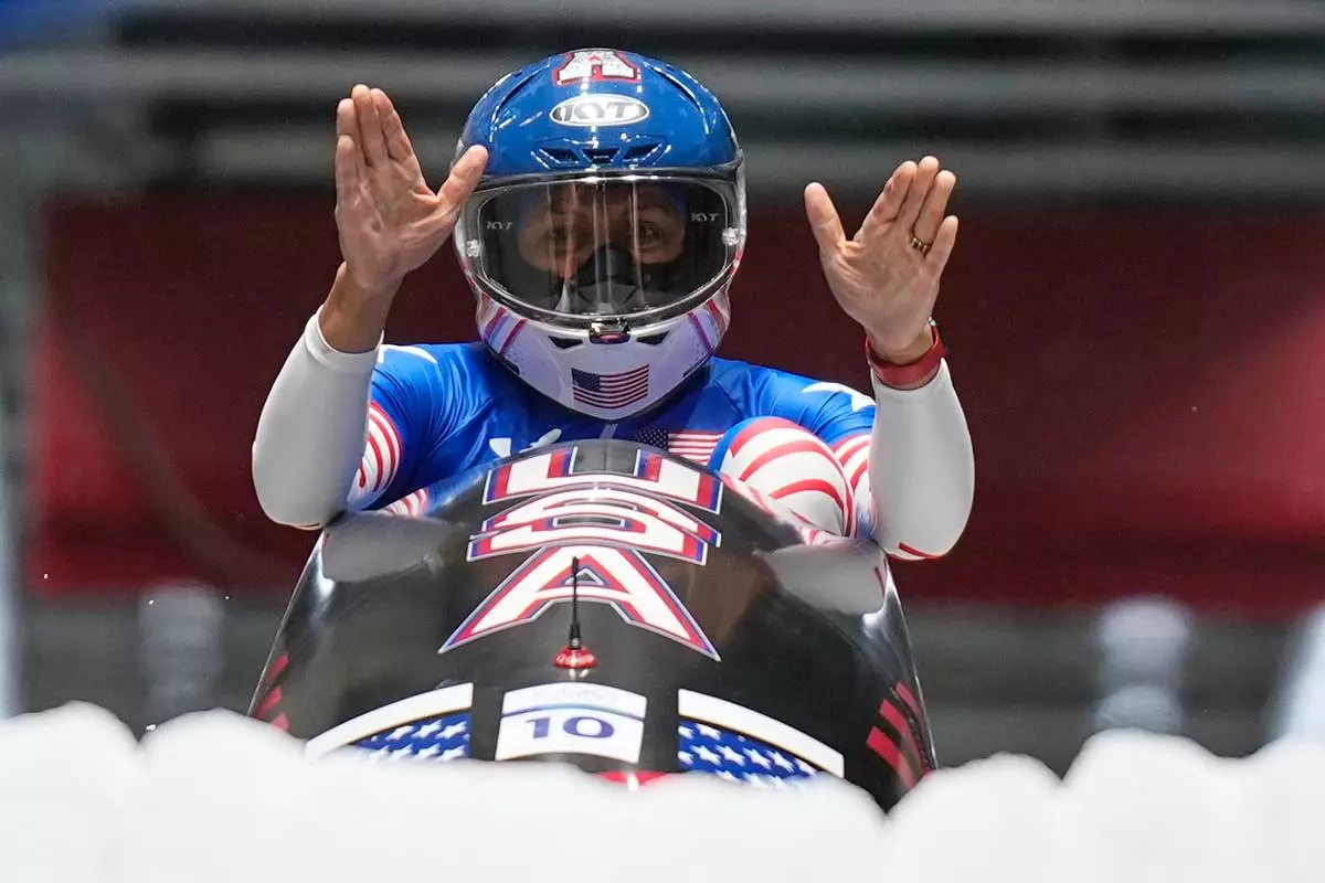 United States' gold medalist Elana Meyers Taylor celebrates at the finish after the women's monobob competition at the 2026 Winter Olympics, in Cortina d'Ampezzo, Italy, Monday, Feb. 16, 2026.(AP Photo/Aijaz Rahi)