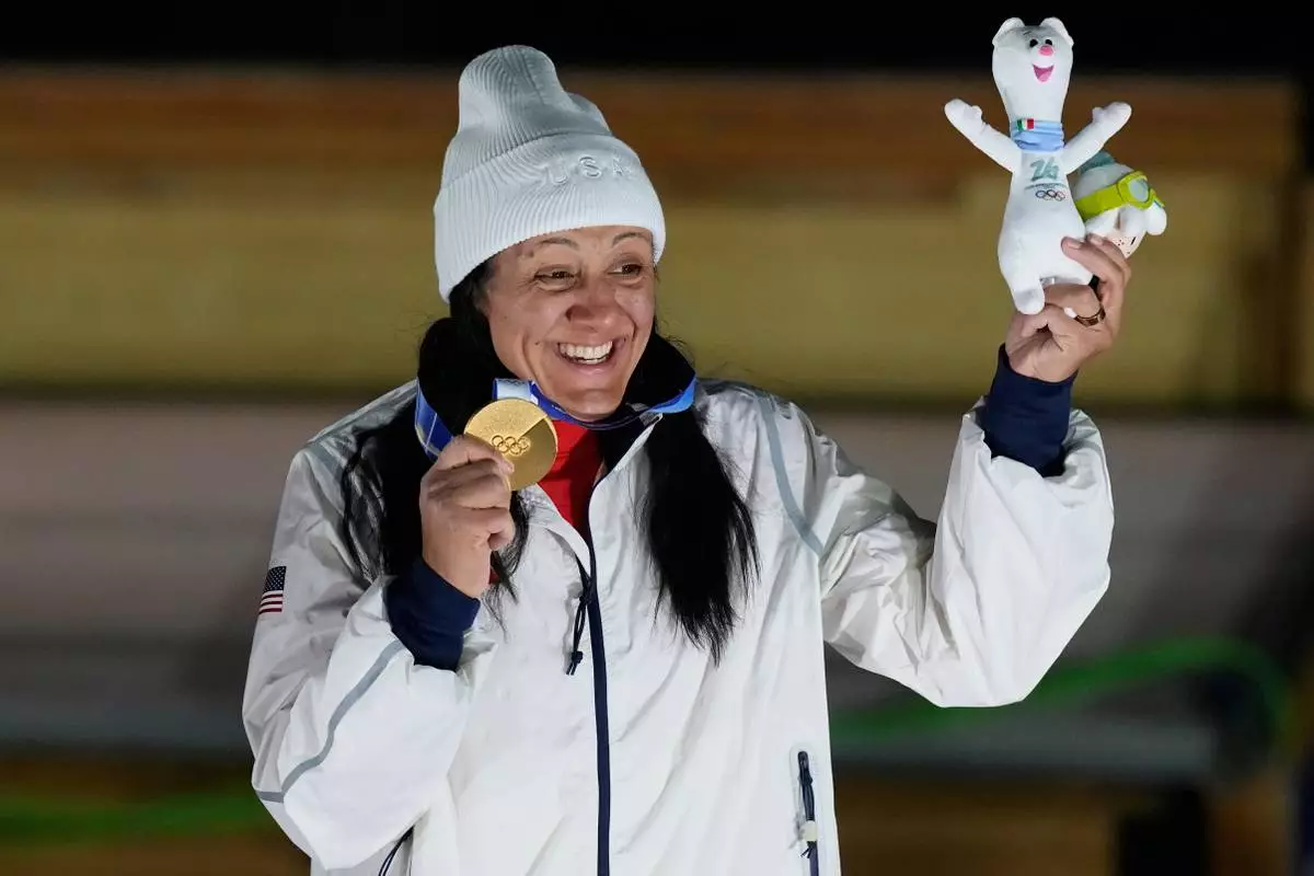 United States' gold medalist Elana Meyers Taylor poses on the podium after the women's monobob competition at the 2026 Winter Olympics, in Cortina d'Ampezzo, Italy, Monday, Feb. 16, 2026. (AP Photo/Aijaz Rahi)