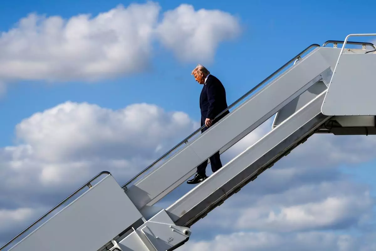 FILE - President Donald Trump disembarks Air Force One at Palm Beach International Airport, Jan. 16, 2026, in West Palm Beach, Fla. (AP Photo/Julia Demaree Nikhinson, File)