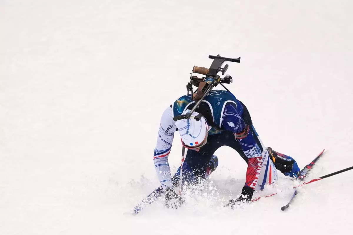 Eric Perrot, of France, reacts in the finish area after winning gold in the men's 4x7.5-kilometer relay biathlon race at the 2026 Winter Olympics in Anterselva, Italy, Tuesday, Feb. 17, 2026. (AP Photo/Andrew Medichini)