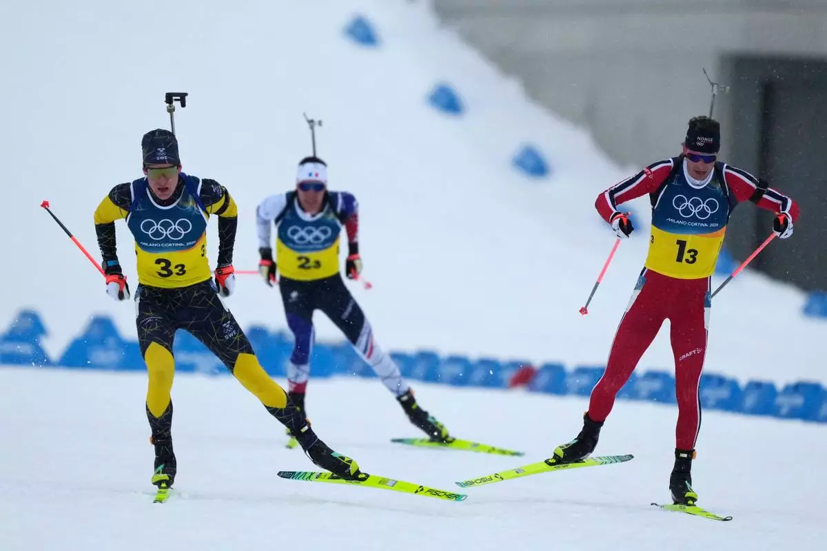 Sturla Holm Laegreid, of Norway, right, Martin Ponsiluoma, of Sweden, left, and Quentin Fillon Maillet, of France, compete in the men's 4x7.5-kilometer relay biathlon race at the 2026 Winter Olympics in Anterselva, Italy, Tuesday, Feb. 17, 2026. (AP Photo/Mosa'ab Elshamy)