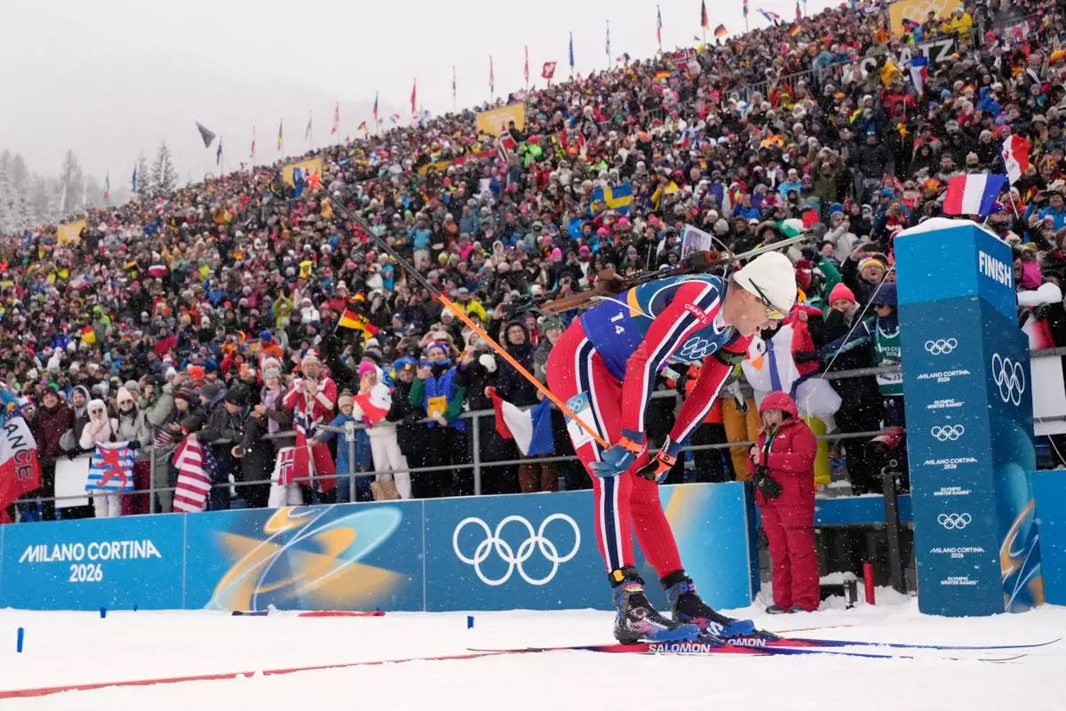 Vetle Sjaastad Christiansen, of Norway, crosses the finish line for silver in the men's 4x7.5-kilometer relay biathlon race at the 2026 Winter Olympics in Anterselva, Italy, Tuesday, Feb. 17, 2026. (AP Photo/David J. Phillip)