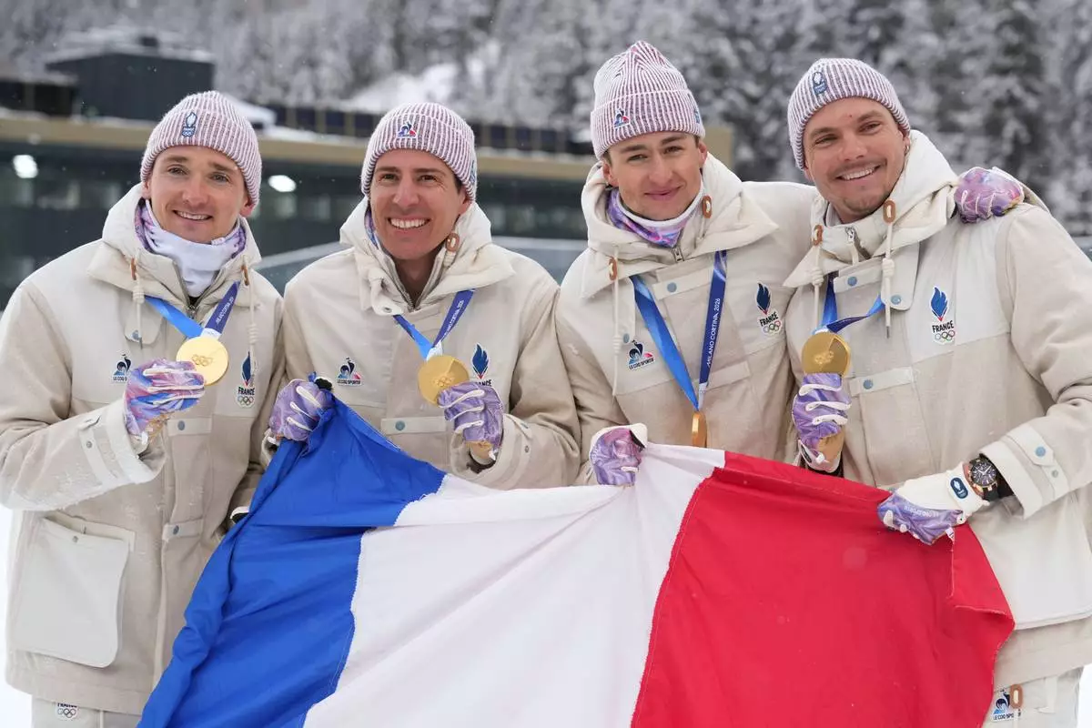 France's Eric Perrot, Quentin Fillon Maillet, Emilien Jacquelin and Fabien Claude pose with the gold medal for the men's 4x7.5-kilometer relay biathlon race at the 2026 Winter Olympics in Anterselva, Italy, Tuesday, Feb. 17, 2026. (AP Photo/Andrew Medichini)