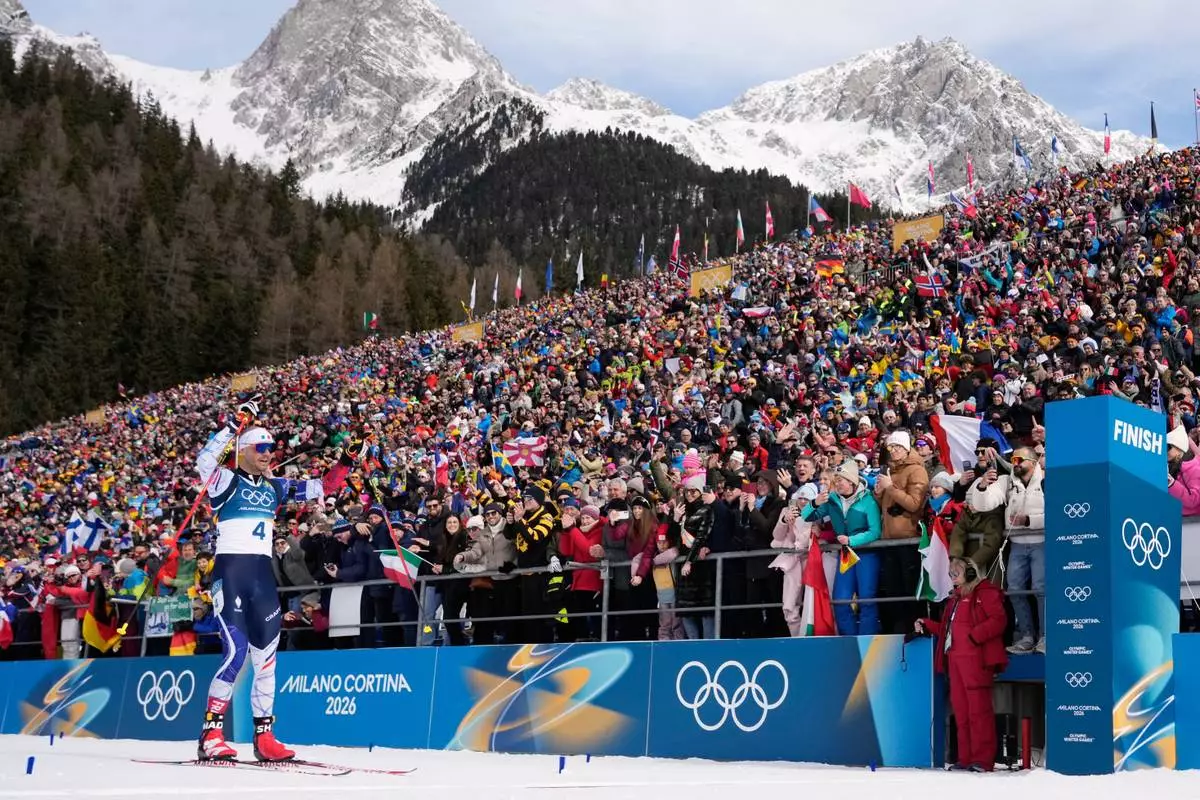 Emilien Jacquelin, of France, crosses the finish line for bronze during the men's 12.5-kilometer pursuit biathlon race at the 2026 Winter Olympics in Anterselva, Italy, Sunday, Feb. 15, 2026. (AP Photo/David J. Phillip)