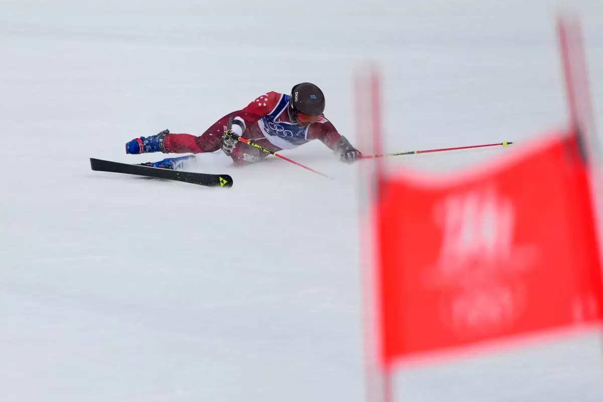 Singapore's Faiz Basha falls during an alpine ski, men's giant slalom race, at the 2026 Winter Olympics, in Bormio, Italy, Saturday, Feb. 14, 2026. (AP Photo/John Locher)