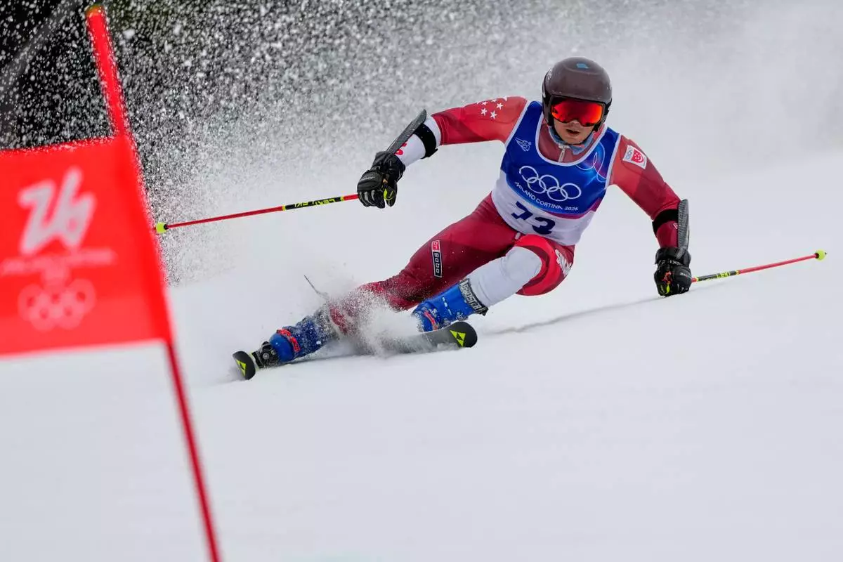 Singapore's Faiz Basha speeds down the course, during an alpine ski, men's giant slalom race, at the 2026 Winter Olympics, in Bormio, Italy, Saturday, Feb. 14, 2026. (AP Photo/John Locher)