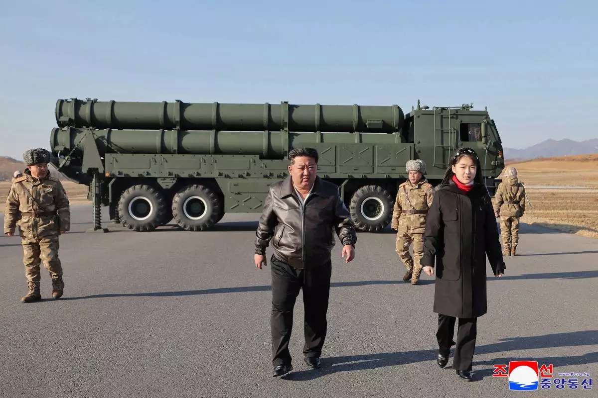 In this photo provided by the North Korean government, its leader Kim Jong Un, with his daughter, believed to be named Kim Ju Ae, inspects test-firing of ballistic missiles from an undisclosed location in North Korea, Tuesday, Jan. 27, 2026. Independent journalists were not given access to cover the event depicted in this image distributed by the North Korean government. The content of this image is as provided and cannot be independently verified. Korean language watermark on image as provided by source reads: "KCNA" which is the abbreviation for Korean Central News Agency. (Korean Central News Agency/Korea News Service via AP)