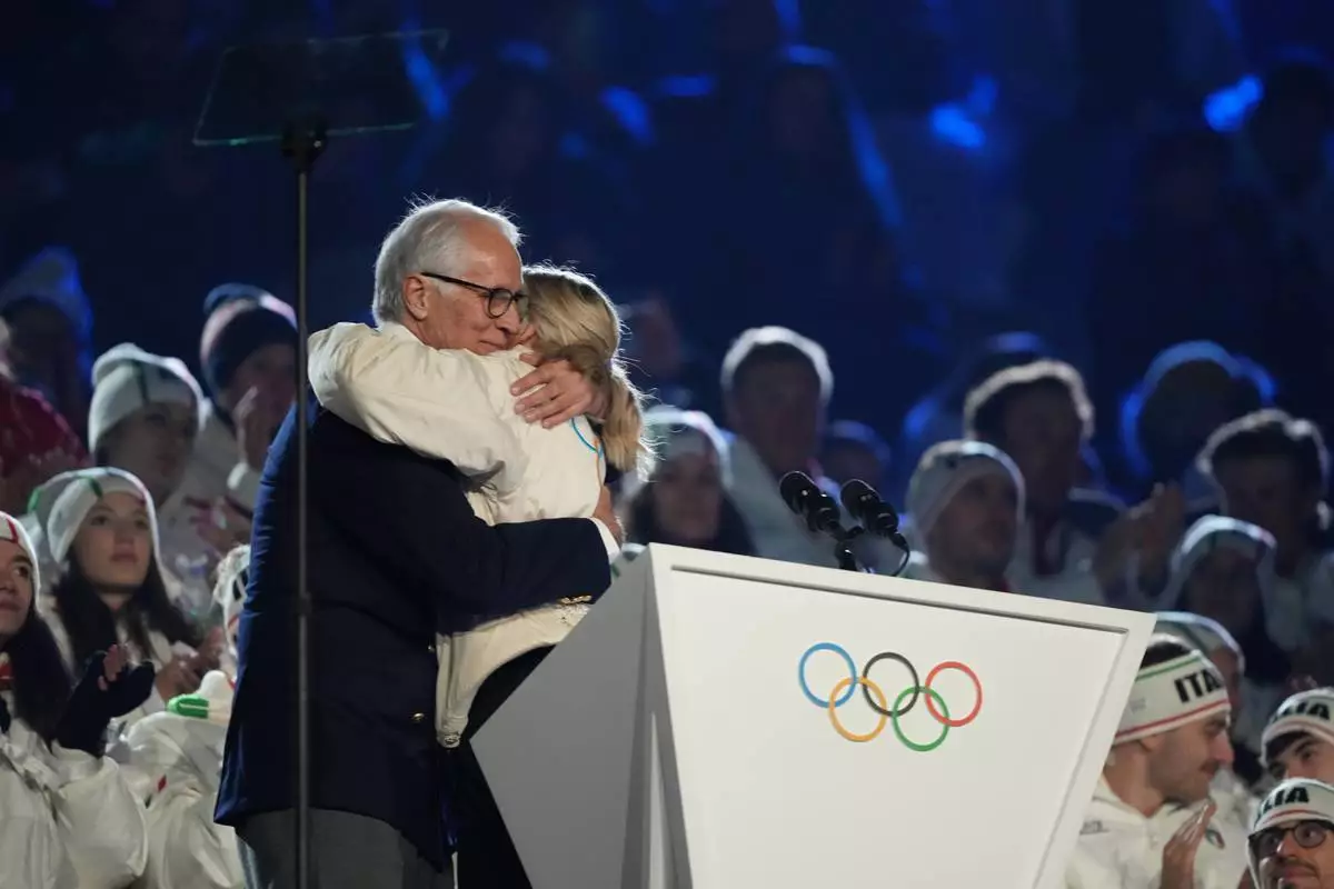 President of the Milan Cortina 2026 foundation Giovanni Malago and IOC President Kirsty Coventry, right, embrace during the closing ceremony of the 2026 Winter Olympics, in Verona, Italy, Sunday, Feb. 22, 2026. (AP Photo/Natacha Pisarenko)
