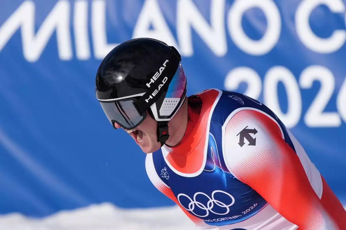 Switzerland's Franjo von Allmen celebrates at the finish area of an alpine ski men's downhill race, at the 2026 Winter Olympics, in Bormio, Italy, Saturday, Feb. 7, 2026. (AP Photo/Rebecca Blackwell)