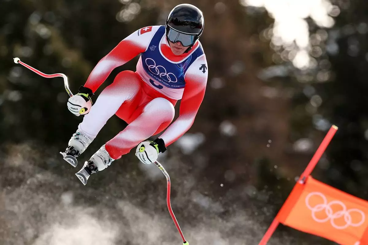 Switzerland's Franjo von Allmen speeds down the course during an alpine ski, men's downhill race, at the 2026 Winter Olympics, in Bormio, Italy, Saturday, Feb. 7, 2026. (AP Photo/Gabriele Facciotti)