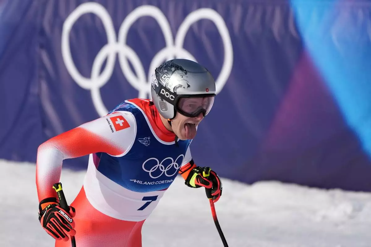 Switzerland's Marco Odermatt celebrates at the finish area of an alpine ski men's downhill race, at the 2026 Winter Olympics, in Bormio, Italy, Saturday, Feb. 7, 2026. (AP Photo/Rebecca Blackwell)