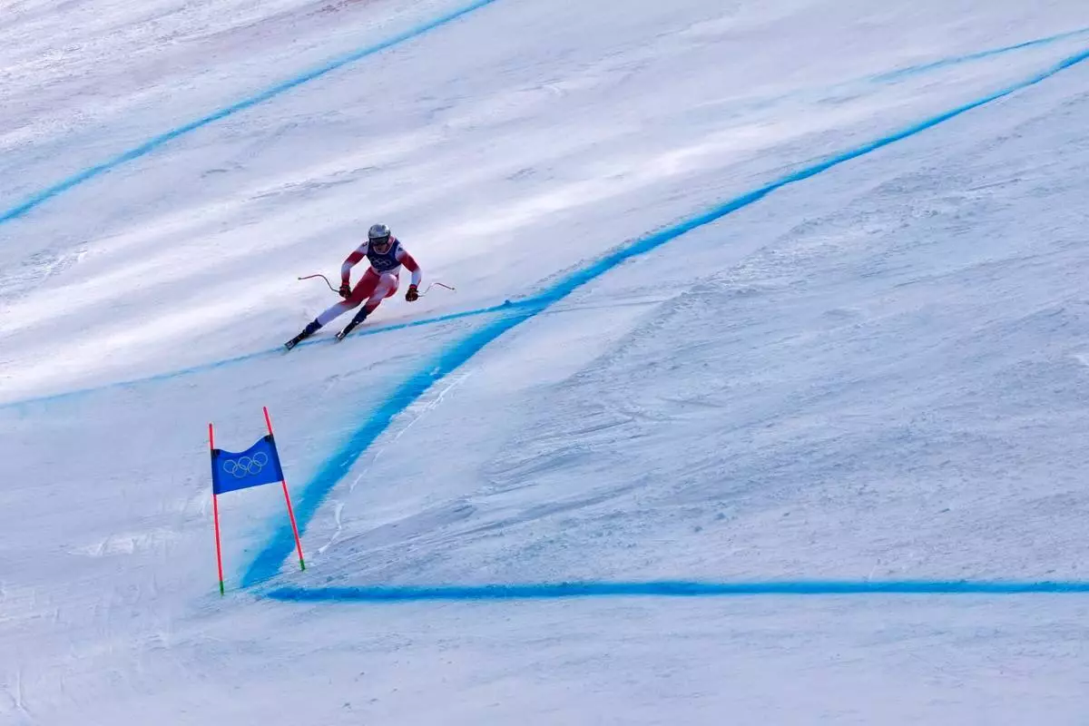 Switzerland's Marco Odermatt speeds down the course during an alpine ski, men's downhill race, at the 2026 Winter Olympics, in Bormio, Italy, Saturday, Feb. 7, 2026. (AP Photo/John Locher)