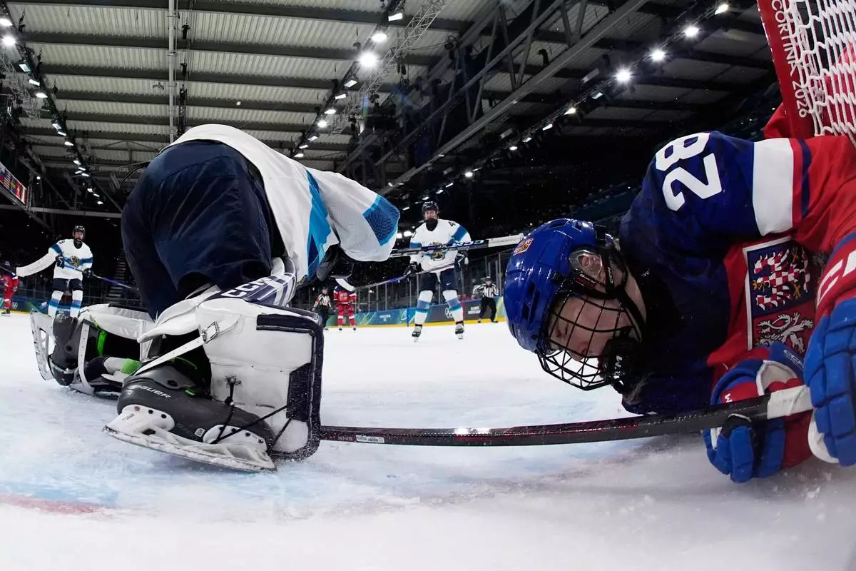 Czechia's Noemi Neubauerova crashes into the goal frame during a preliminary round match of women's ice hockey between Czechia and Finland at the 2026 Winter Olympics, in Milan, Italy, Sunday, Feb. 8, 2026. (AP Photo/Darko Bandic, Pool)