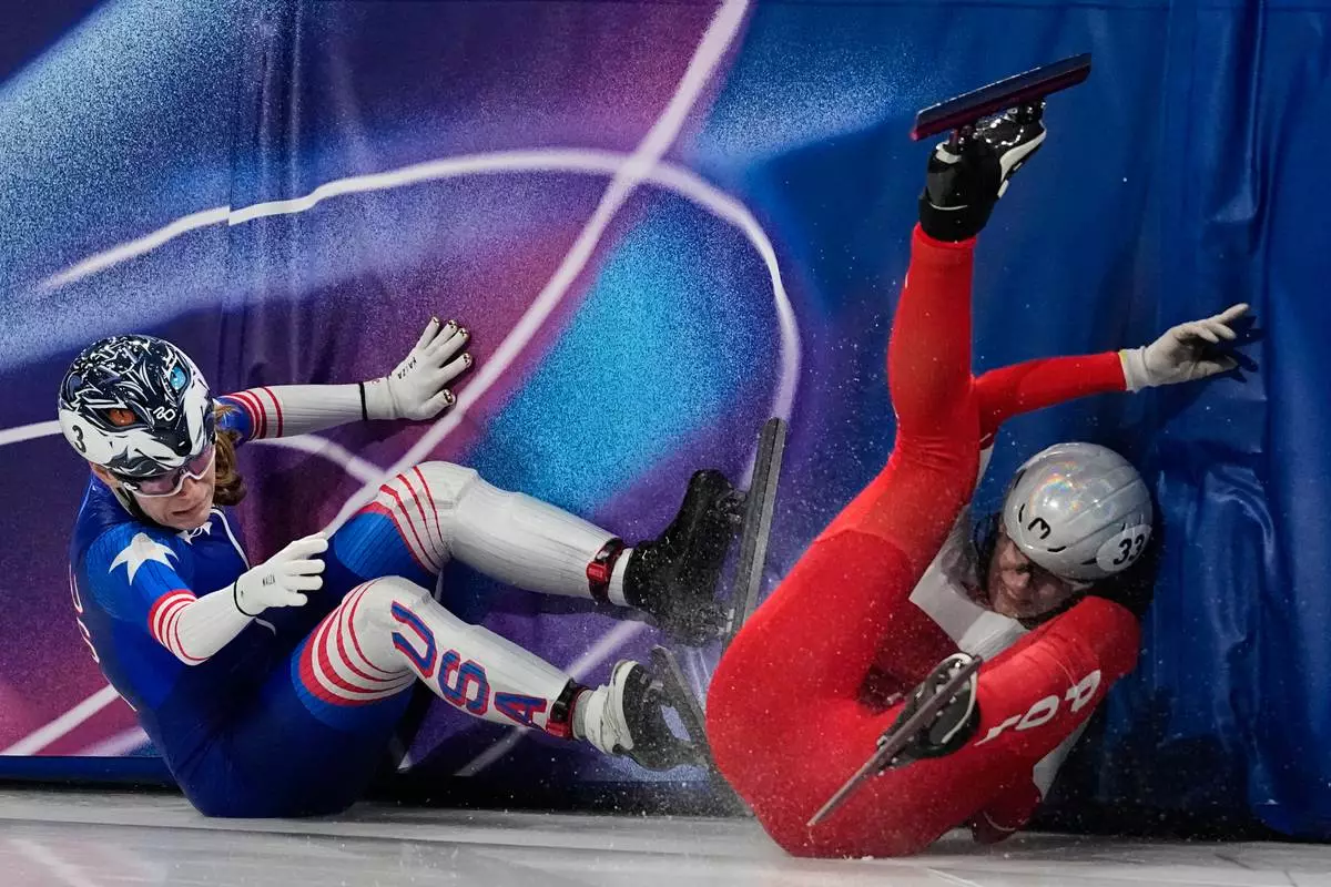 Corinne Stoddard of the United States crashes into Gabriela Topolska of Poland in the quarterfinals of the women's 1000 meter short track speed skating at the 2026 Winter Olympics, in Milan, Italy, Saturday, Feb. 14, 2026. (AP Photo/Ashley Landis)