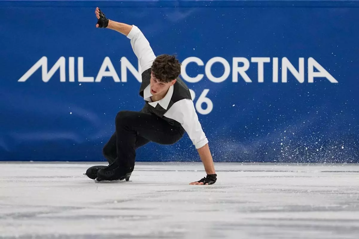 Lukas Britschgi of Switzerland falls during the men's figure skating short program at the 2026 Winter Olympics, in Milan, Italy, Tuesday, Feb. 10, 2026. (AP Photo/Ashley Landis)