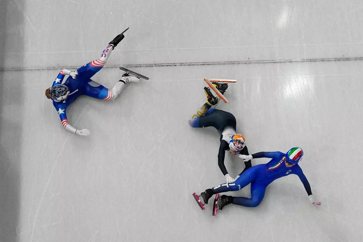Italy's Arianna Sighel, right, United States' Corinne Stoddard, left, and Japan's Rika Kanai fall as they compete during the women's 500 meters short track speed skating heats race at the 2026 Winter Olympics, in Milan, Italy, Tuesday, Feb. 10, 2026. (AP Photo/Christophe Ena)