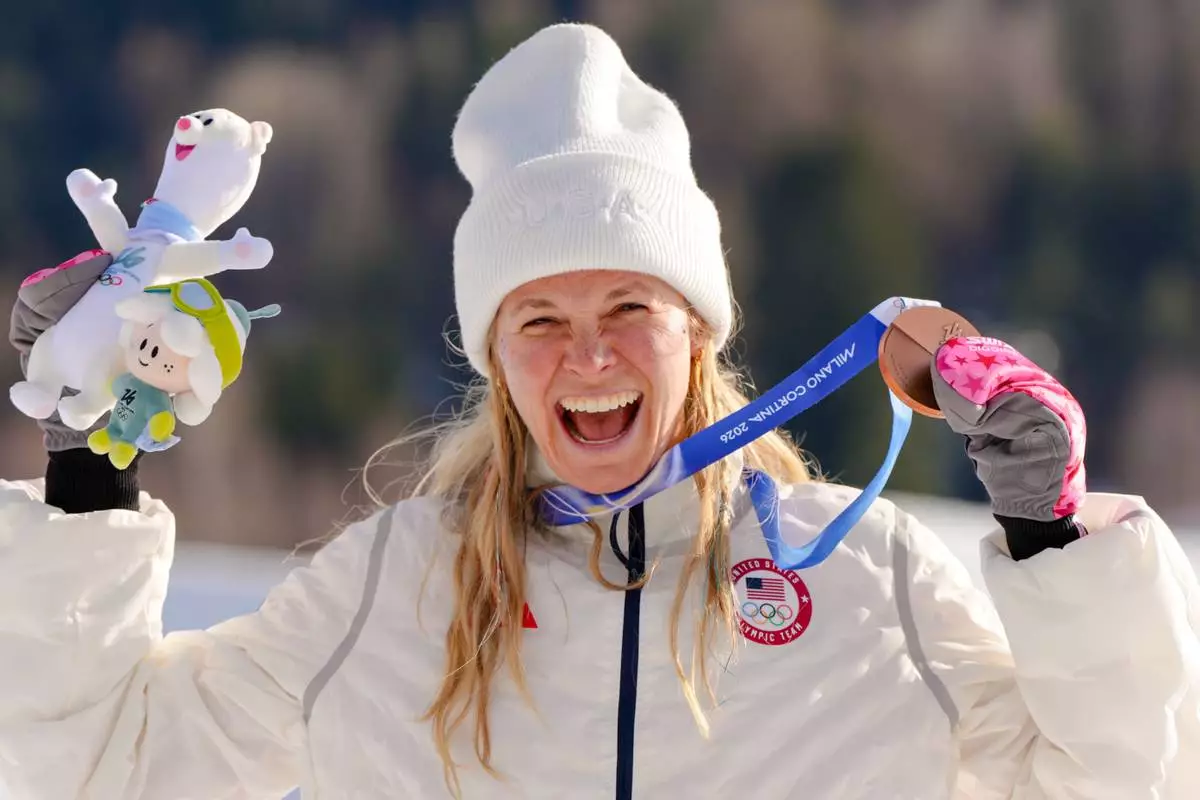 Jessie Diggins, of the United States, poses after winning the bronze medal in the cross country skiing women's 10km interval start free at the 2026 Winter Olympics, in Tesero, Italy, Thursday, Feb. 12, 2026. (AP Photo/Kirsty Wigglesworth)