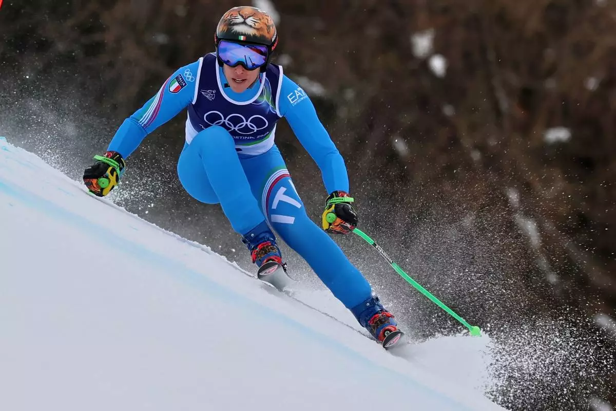 Italy's Federica Brignone speeds down the course, during an alpine ski, women's super-G race, at the 2026 Winter Olympics, in Cortina d'Ampezzo, Italy, Thursday, Feb. 12, 2026. (AP Photo/Marco Trovati)