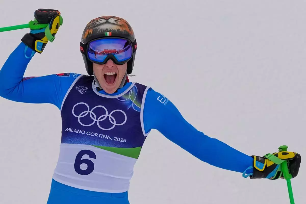 Italy's Federica Brignone reacts in the finish area, during an alpine ski, women's super-G race, at the 2026 Winter Olympics, in Cortina d'Ampezzo, Italy, Thursday, Feb. 12, 2026. (AP Photo/Andy Wong)