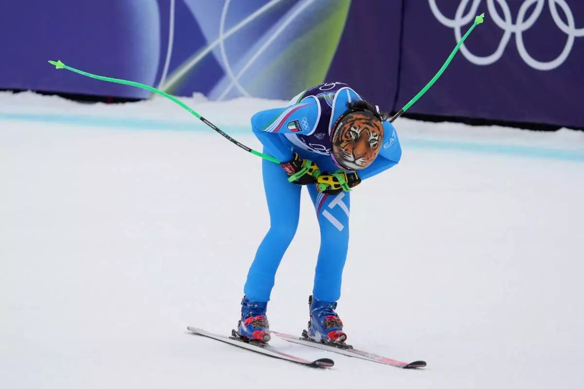 Italy's Federica Brignone celebrates at the finish area of an alpine ski, women's super-G race, at the 2026 Winter Olympics, in Cortina d'Ampezzo, Italy, Thursday, Feb. 12, 2026. (AP Photo/Jacquelyn Martin)