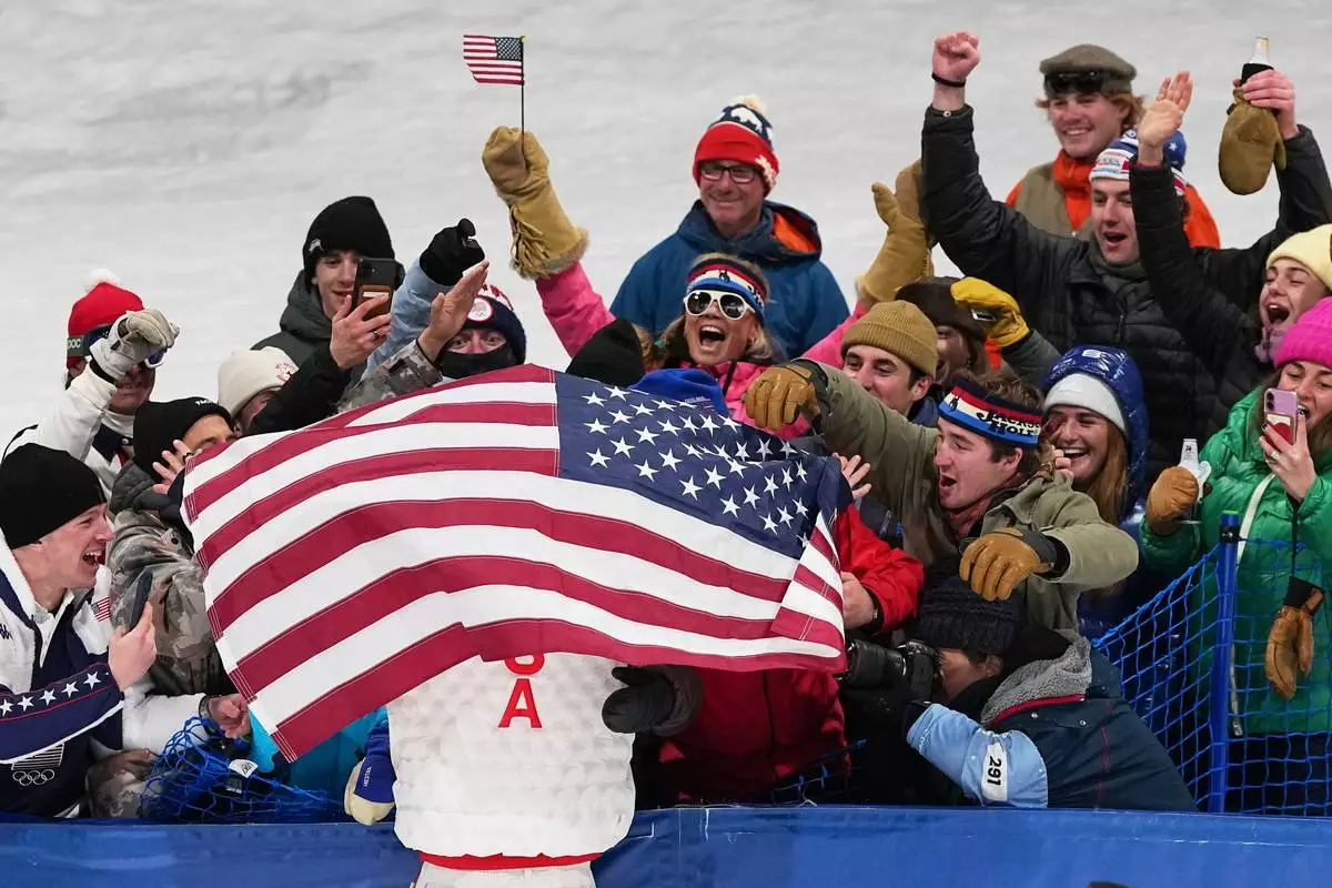 Gold medalist United States' Alex Ferreira celebrates in the stands after the men's freestyle skiing halfpipe finals at the 2026 Winter Olympics, in Livigno, Italy, Friday, Feb. 20, 2026. (AP Photo/Gregory Bull)