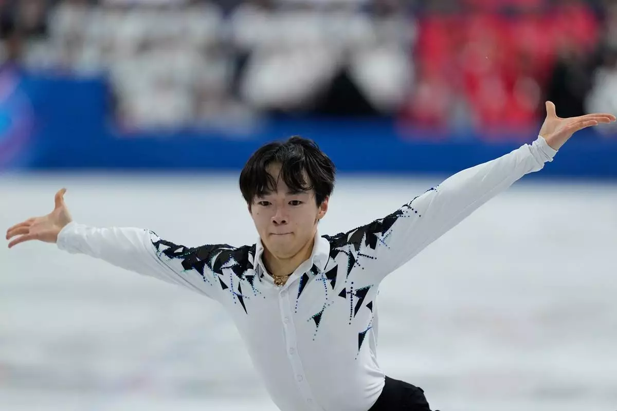Yuma Kagiyama of Japan competes during the figure skating men's team event at the 2026 Winter Olympics, in Milan, Italy, Saturday, Feb. 7, 2026. (AP Photo/Natacha Pisarenko)