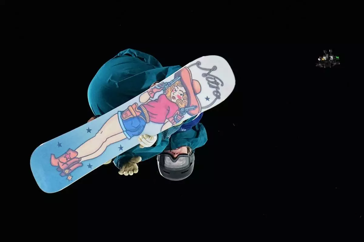 Finland's Eveliina Taka competes during the women's snowboard big air qualifications as a drone flies nearby at the 2026 Winter Olympics, in Livigno, Italy, Sunday, Feb. 8, 2026. (AP Photo/Gregory Bull)