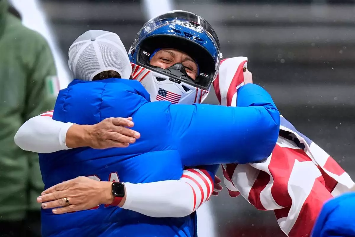 United States' gold medalist Elana Meyers Taylor celebrates at the finish after the women's monobob competition at the 2026 Winter Olympics, in Cortina d'Ampezzo, Italy, Monday, Feb. 16, 2026.(AP Photo/Aijaz Rahi)