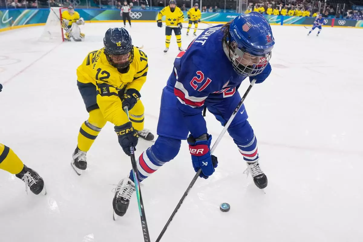 United States' Hilary Knight, right, challenges for the puck with Sweden's Maja Nylen Persson during a semifinal match of women's ice hockey between the United States and Sweden at the 2026 Winter Olympics, in Milan, Italy, Monday, Feb. 16, 2026. (AP Photo/Petr David Josek)