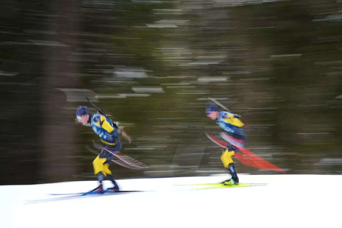 Athletes from Sweden participate in a biathlon training session at the 2026 Winter Olympics in Anterselva, Italy, Saturday, Feb. 7, 2026. (AP Photo/Andrew Medichini)