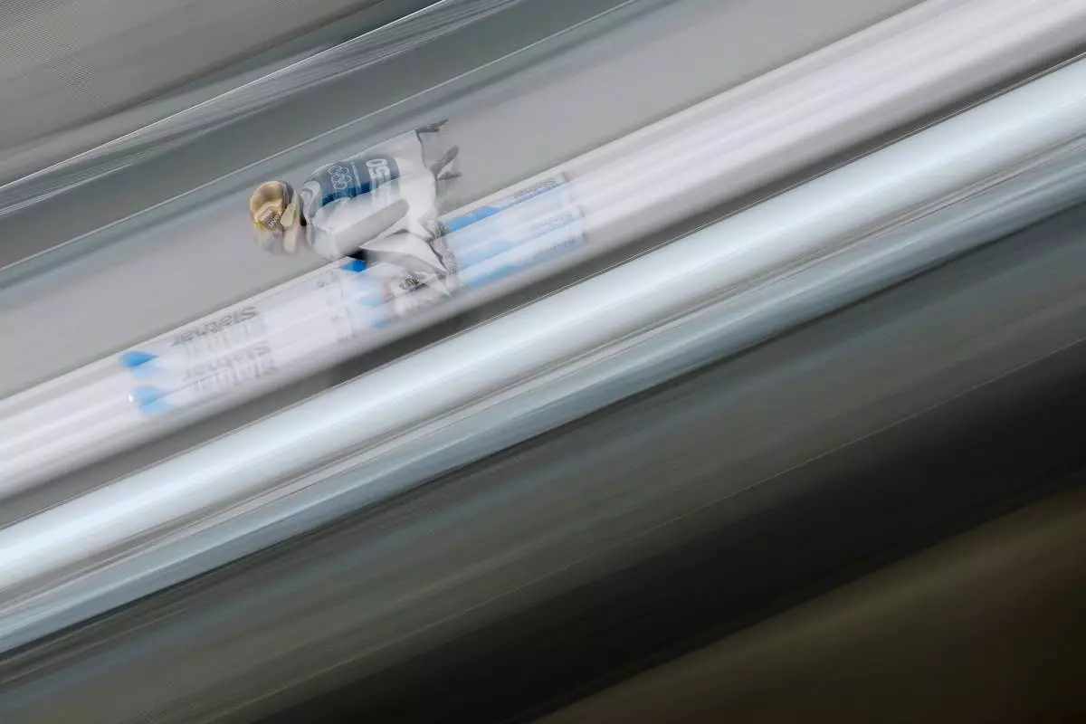 Domen Prevc, of Slovenia, goes down the ramp during a ski jumping, men's normal hill, training session, at the 2026 Winter Olympics, in Predazzo, Italy, Sunday, Feb. 8, 2026. (AP Photo/Matthias Schrader)
