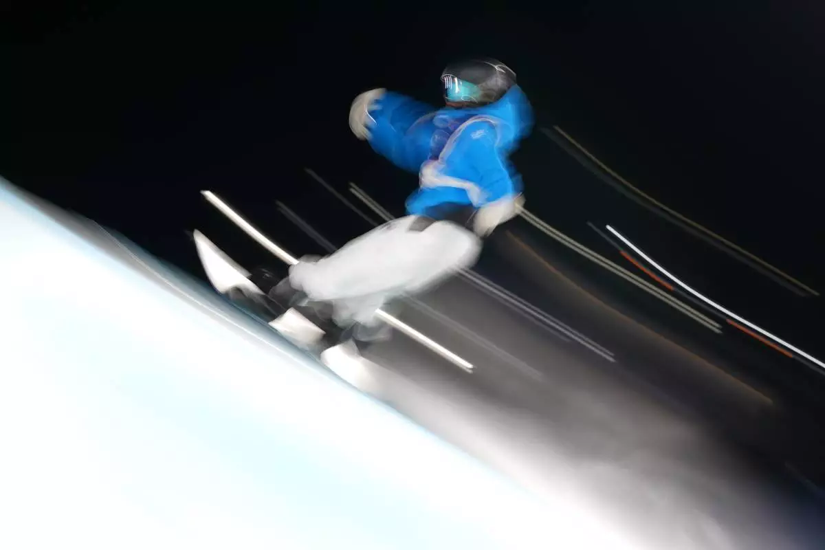 Italy's Marilu Poluzzi competes during the women's snowboard big air qualifications at the 2026 Winter Olympics, in Livigno, Italy, Sunday, Feb. 8, 2026. (AP Photo/Abbie Parr)