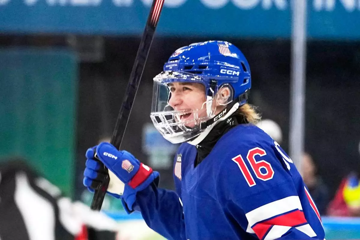 United States' Hayley Scamurra (16) celebrates after scoring her side's fifth goal during a women's ice hockey semifinal game between the United States and Sweden at the 2026 Winter Olympics, in Milan, Italy, Monday, Feb. 16, 2026. (AP Photo/Hassan Ammar)