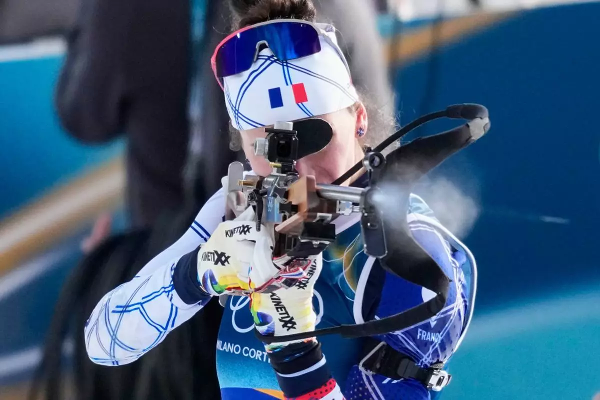 France's Julia Simon shoots during the 4x6-kilometer mixed relay biathlon race at the 2026 Winter Olympics, in Anterselva, Italy, Sunday, Feb. 8, 2026. (AP Photo/David J. Phillip)