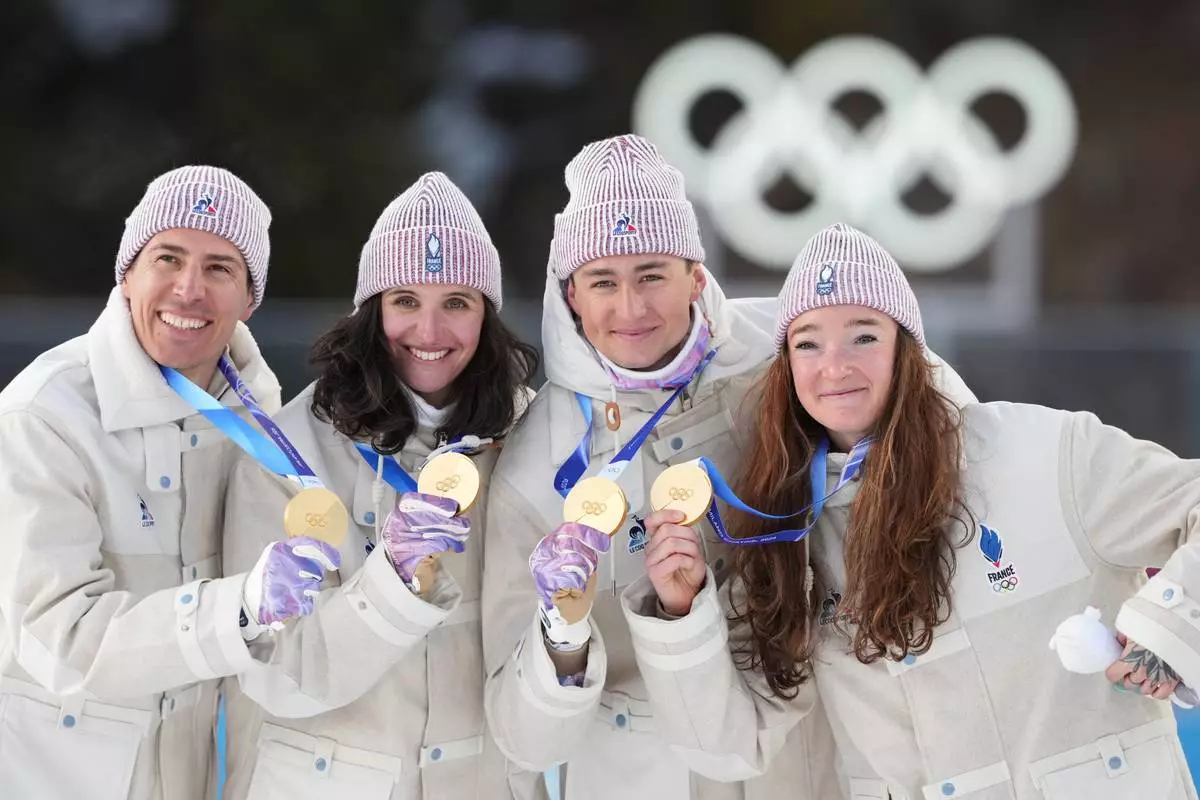France's Julia Simon, Lou Jeanmonnot, Quentin Fillon Maillet and Eric Perrot pose with their gold medals in the 4X6-kilometer mixed relay biathlon race at the 2026 Winter Olympics in Anterselva, Italy, Sunday, Feb. 8, 2026. (AP Photo/Andrew Medichini)