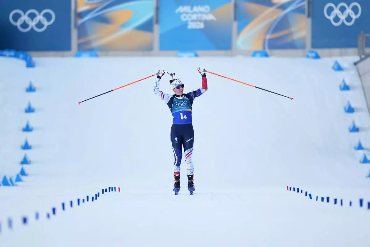 Julia Simon, of France, reacts as her team wins gold in the 4X6-kilometer mixed relay biathlon race at the 2026 Winter Olympics in Anterselva, Italy, Sunday, Feb. 8, 2026. (AP Photo/Andrew Medichini)