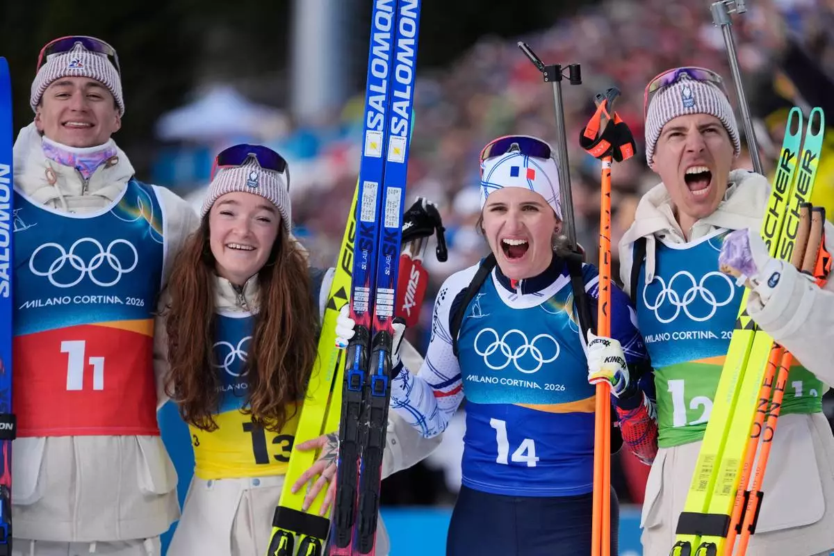 France's Eric Perrot, from left, Lou Jeanmonnot, Julia Simon and Quentin Fillon Maillet celebrate winning gold in the 4X6-kilometer mixed relay biathlon race at the 2026 Winter Olympics in Anterselva, Italy, Sunday, Feb. 8, 2026. (AP Photo/Andrew Medichini)