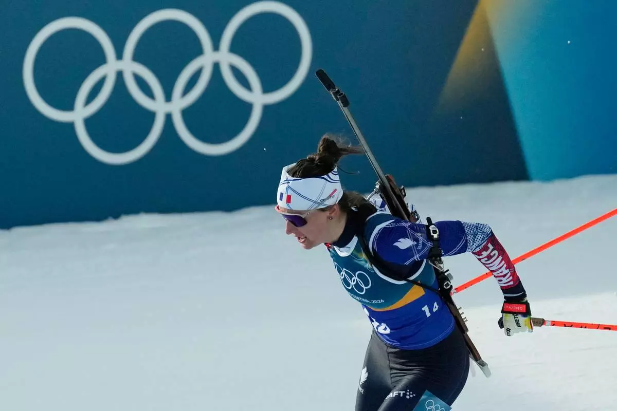 Julia Simon, of France, competes in the 4X6-kilometer mixed relay biathlon race at the 2026 Winter Olympics in Anterselva, Italy, Sunday, Feb. 8, 2026. (AP Photo/Mosa'ab Elshamy)